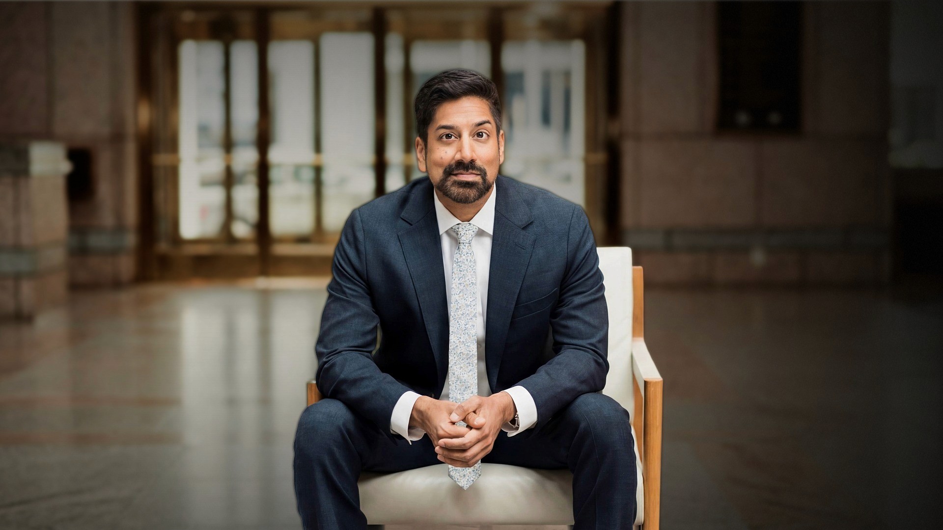 Photograph of Dr. Amar Rewari sitting in a chair.